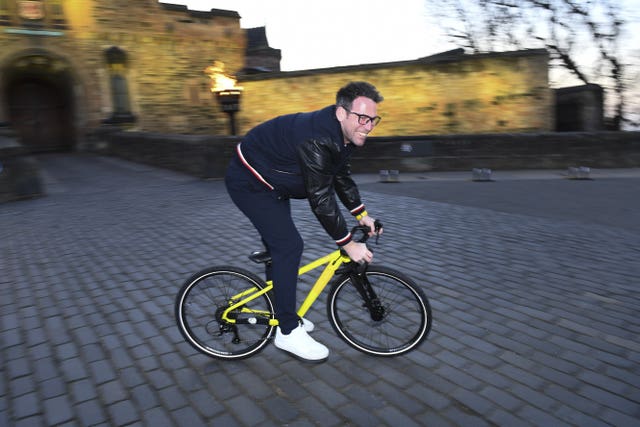 Mark Cavendish riding a bike outside pictured at Edinburgh Castle