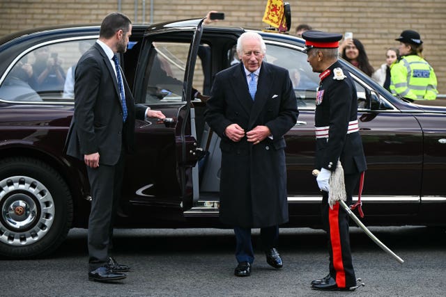 Charles steps from his Bentley after arriving in Deptford