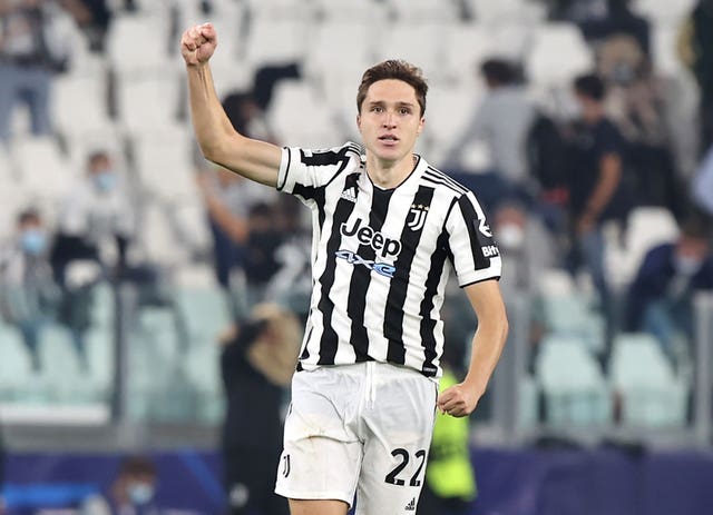 Federico Chiesa holds up his right arm in celebration playing 