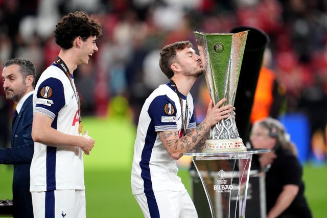 Tottenham’s James Maddison kisses the trophy