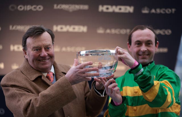 Nicky Henderson and jockey Nico de Boinville with the trophy after winning the BetMGM Clarence House Chase 