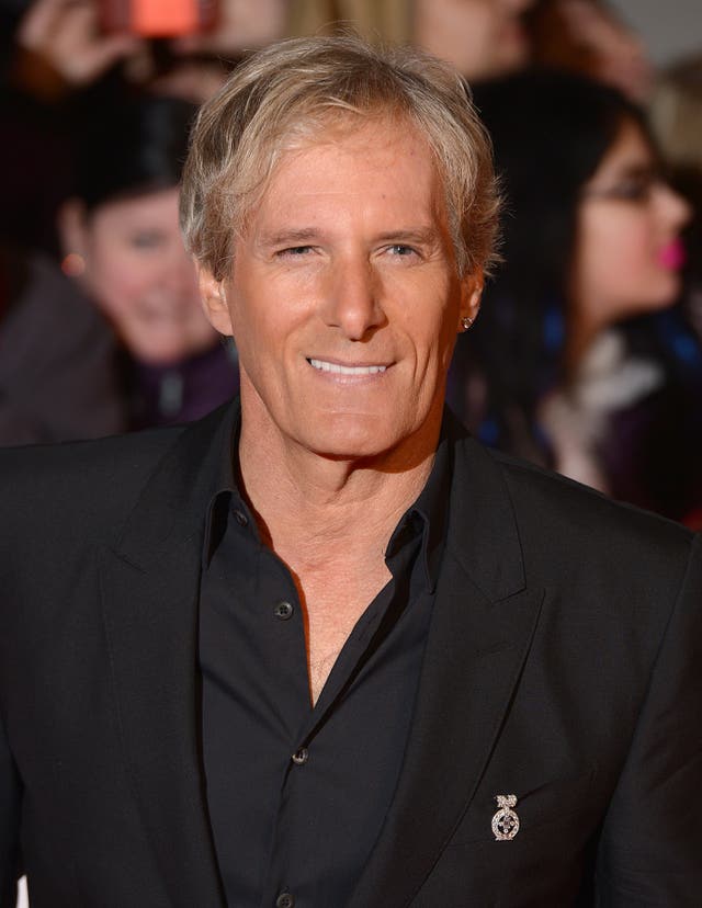 Michael Bolton in a black open-necked shirt and black suit jacket at the National Television Awards in 2014