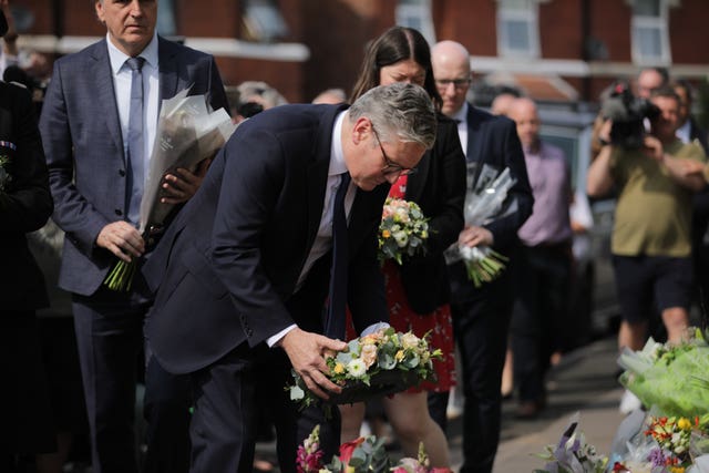 Prime Minister Keir Starmer places a floral tribute near the scene of the fatal knife attack in Southport