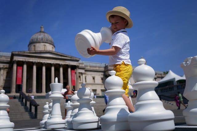 A young boy takes part in ChessFest, the UK’s largest one-day chess event, at Trafalgar Square, central London