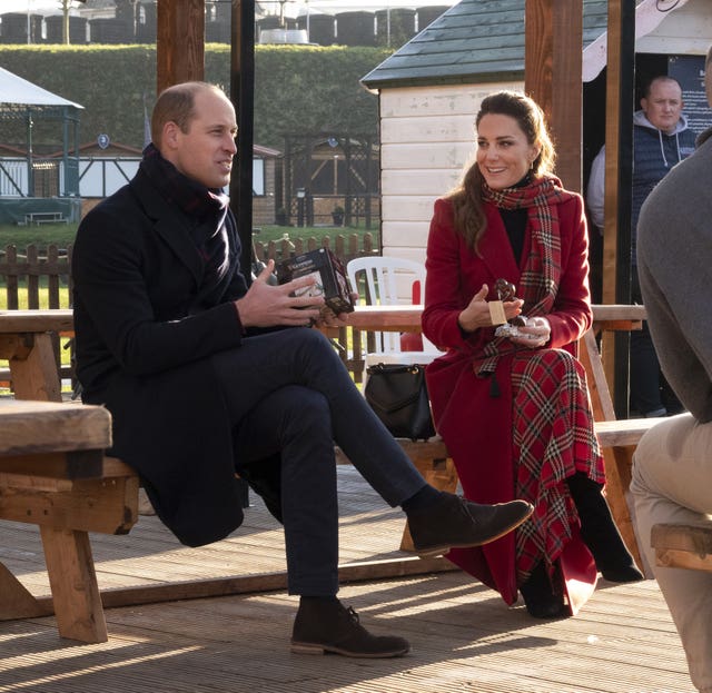 The Duke and Duchess of Cambridge open Secret Santa gifts during a visit to meet students at the ‘Christmas at the Castle’ event held at Cardiff Castle to hear how they have been supported with their mental health during lockdown