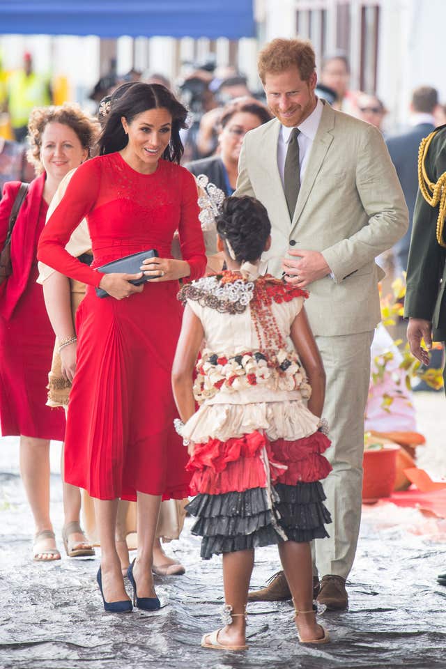 Meghan was wearing a red dress by Self-Portrait