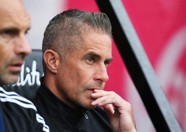 Sylvinho sitting in the dugout 