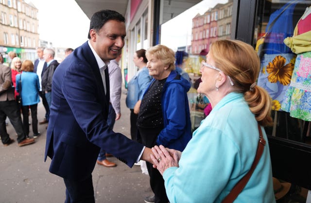 Scottish Labour leader Anas Sarwar shaking hands with a woman during a walkabout in Clarkston, East Renfrewshire