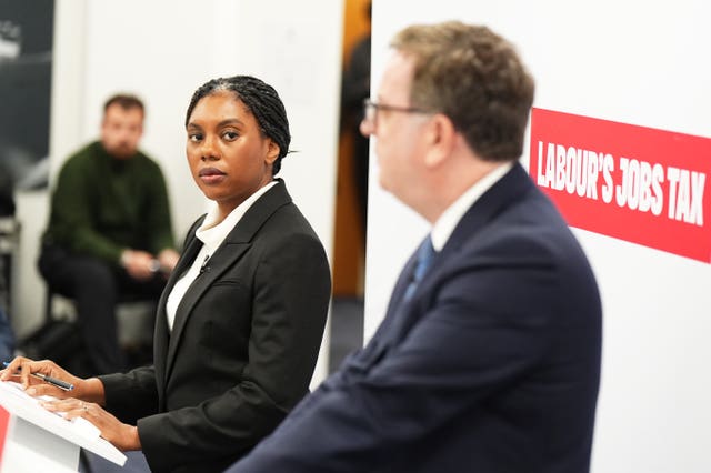 Kemi Badenoch and Mel Stride give a press conference in front of a sign reading 'Labour's jobs tax'
