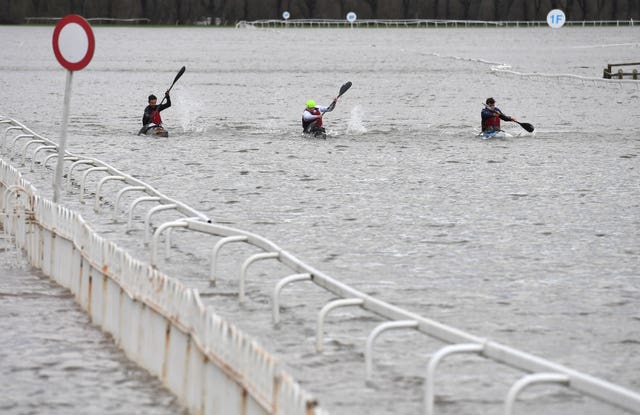 Kayakers on a flooded Worcester racecourse