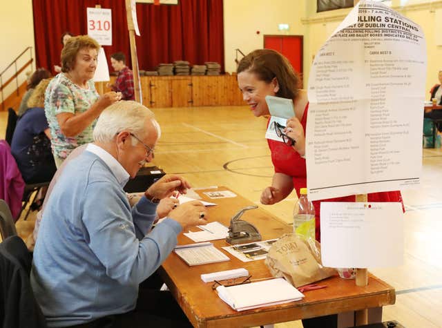 Sinn Fein leader Mary Lou McDonald presents her identity documents at St Joseph’s School, Dublin (Niall Carson/PA)