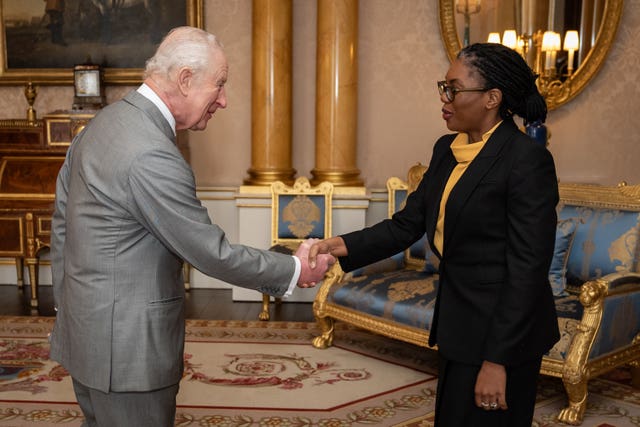 The King and Kemi Badenoch shaking hands