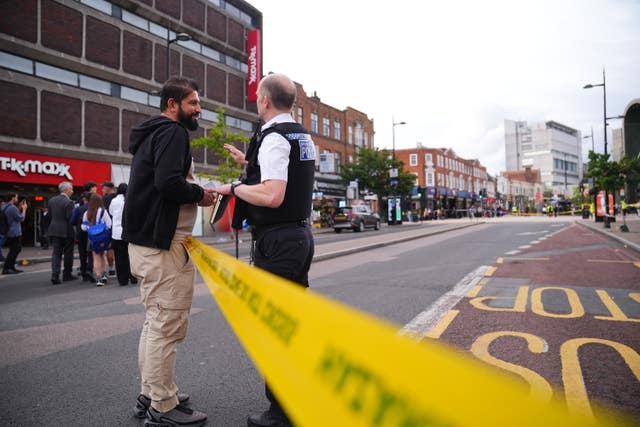 A police officer speaks to a member of the public