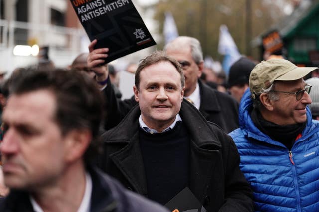 Minister of State for Security Tom Tugendhat, centre, takes part in the rally 