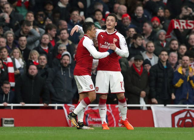 Unlike Sanchez (left) who moved to Man Utd, Ozil signed a new deal at Arsenal (Jonathan Brady/PA)