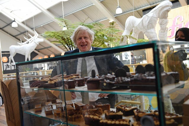 Prime Minister Boris Johnson looks at a display of cakes in Truro, Cornwall (Justin Tallis/PA)