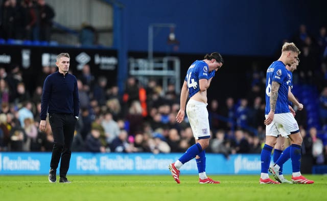 Ipswich manager Kieran McKenna, left, and players Jacob Greaves, Luke Woolfenden and Jack Taylor leave the pitch after defeat to Tottenham