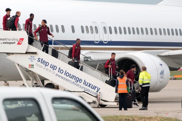 Salah was one of the first players off the plane as Liverpool returned home