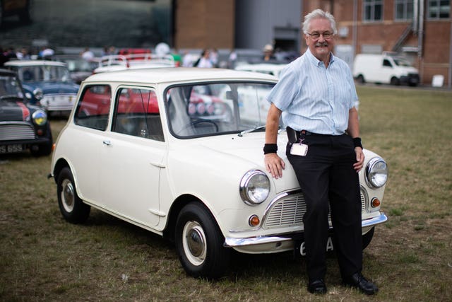 Mick Fisher, 70, the factory's longest serving employee, with the first production Mini (Aaron Chown/PA)