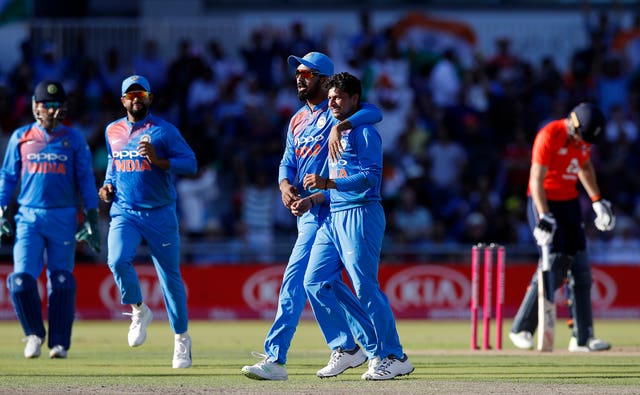 Kuldeep Yadav, right, is congratulated after taking the wicket of Eoin Morgan, background, at Old Trafford