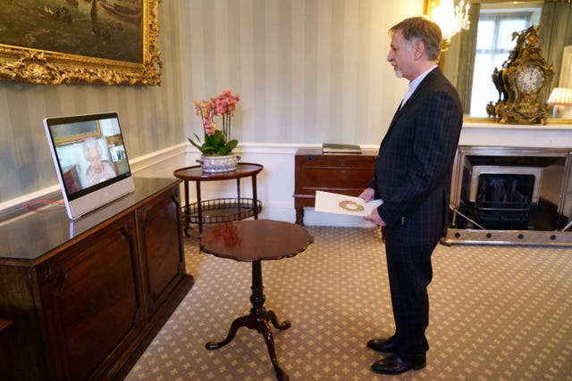 The Queen appears on a screen via videolink from Windsor Castle, where she is in residence, during a virtual audience to receive His Excellency Mohsen Baharvand, the Ambassador of Iran, at Buckingham Palace in July 2021