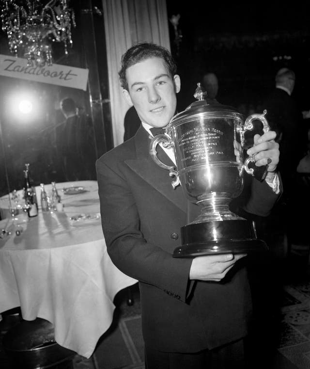 A 21-year-old Stirling Moss with the Richard Seaman Trophy for the British driver who gained the most points in foreign races