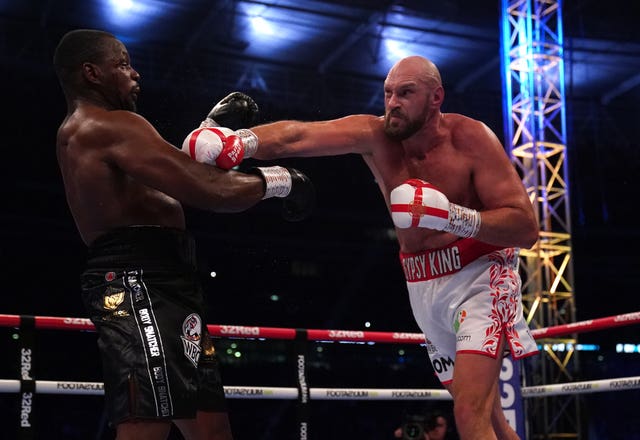 Dillian Whyte is knocked out by Tyson Fury (right)