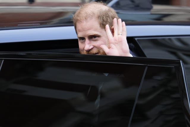 Duke of Sussex waves while getting into a car