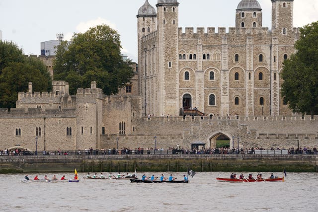 Boats pass the Tower of London in central London