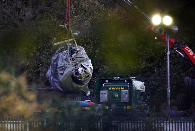A crane moves part of the wreckage (Aaron Chown/PA)