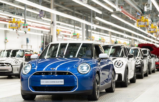 A line of new Mini Cooper Electric on the production line at the BMW Mini plant at Cowley in Oxford