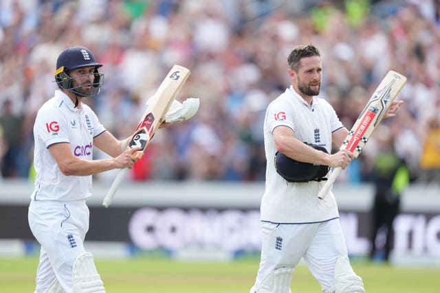 Chris Woakes, right, and Mark Wood leave the field after hitting the winning runs