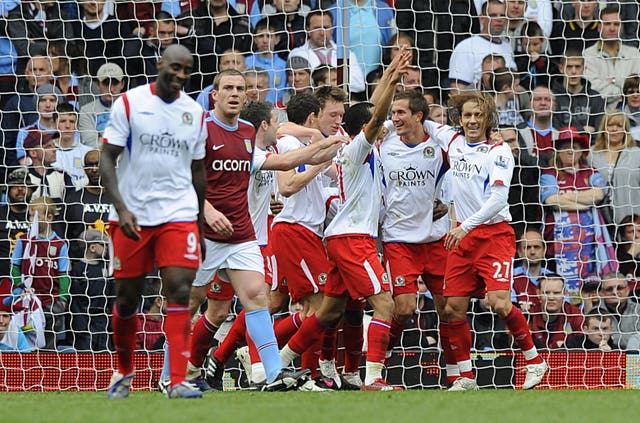 Richard Dunne, second left, reacts as Blackburn players celebrate his own goal