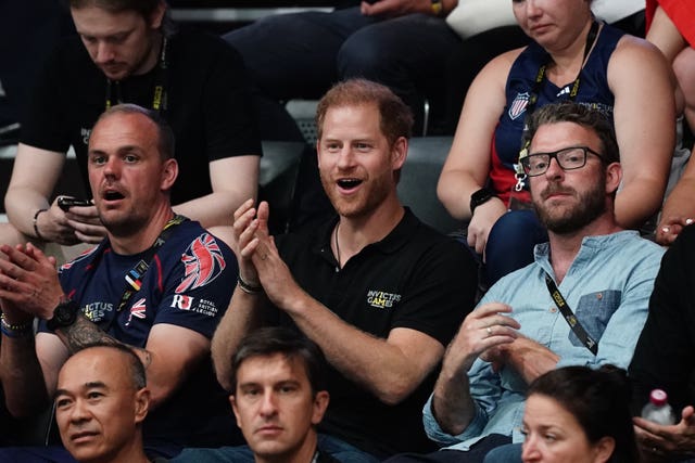 The Duke of Sussex and TV presenter JJ Chalmers cheer on Invictus competitors