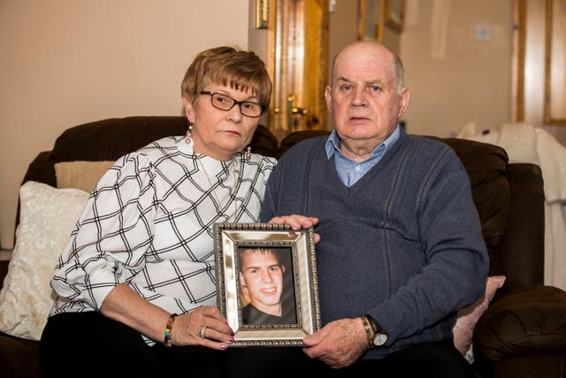 Stephen and Breege Quinn hold an image of their murdered son Paul
