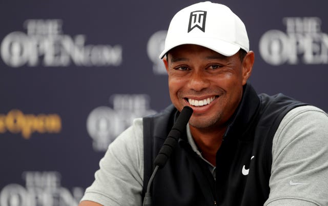 Tiger Woods smiles during a press conference