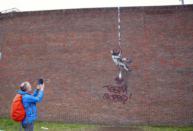 The Banksy artwork which was painted on the side of the former prison in Reading has now been defaced