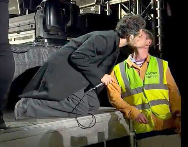 Matty Healy kisses crowd safety worker