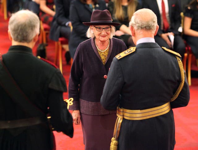Liz Calder speaks with the Prince of Wales as she is presented with her honour (Jonathan Brady/PA)