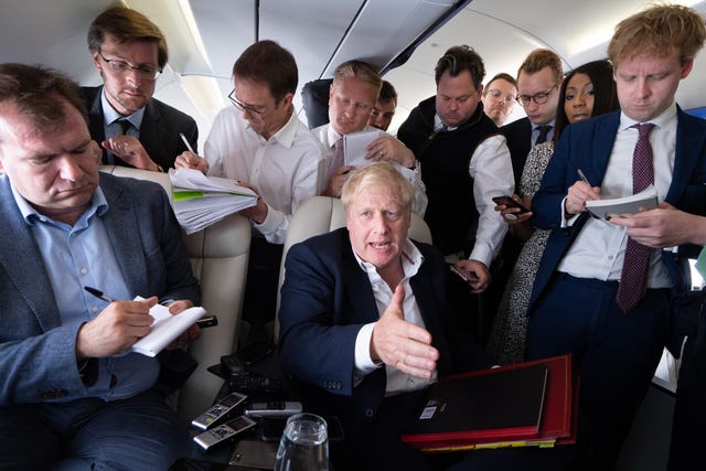 Boris Johnson surrounded by journalists