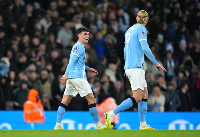 Phil Foden (left) celebrates his goal with Erling Haaland