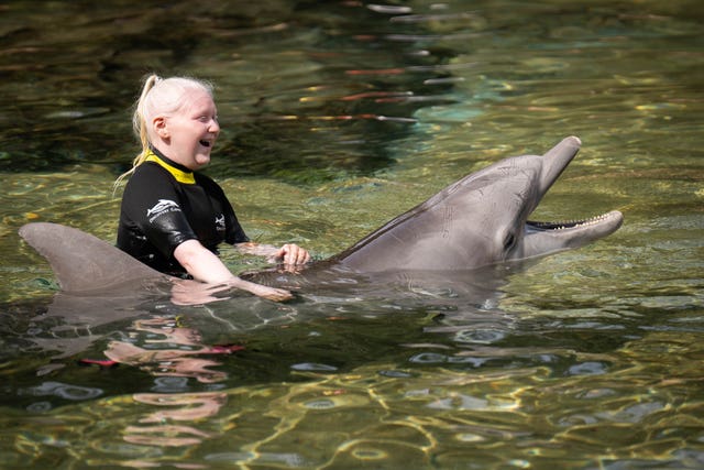 Daria Comedie swims with a dolphin 