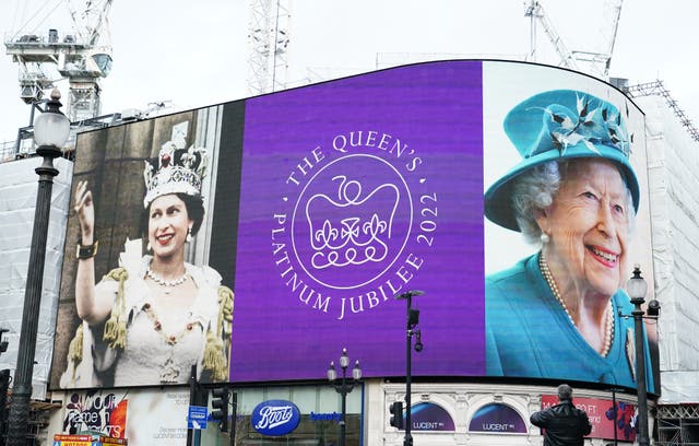 Queen on a billboard in London's Piccadilly Circus)