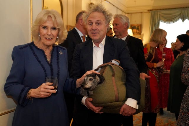 The Queen with author Charlie Mackesy and his dog Barney at a Reading Room reception at Clarence House in 2023 