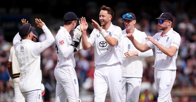 Ollie Robinson (centre) celebrates with team-mates after a wicket