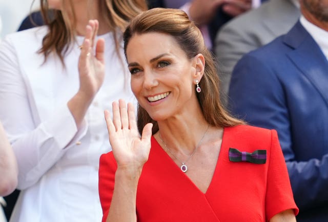 Kate waves from the royal box