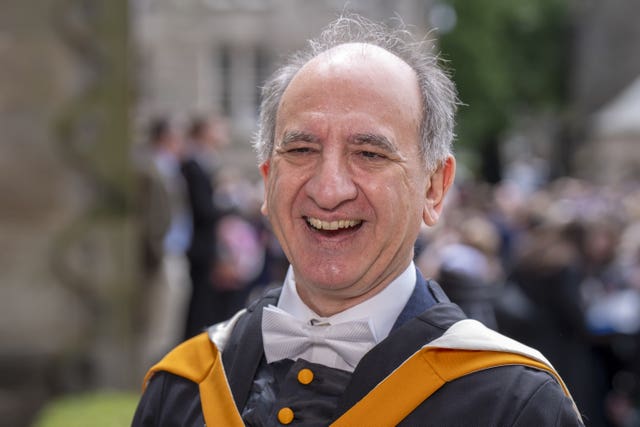 Armando Iannucci smiling while dressed in a graduation gown