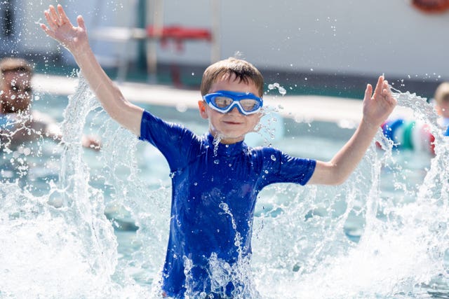 Bruce Ferrol, six, cools off from the hot weather at Cumnock open-air swimming pool in East Ayrshire 
