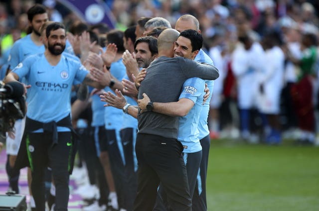 Pep Guardiola and Mikel Arteta embrace