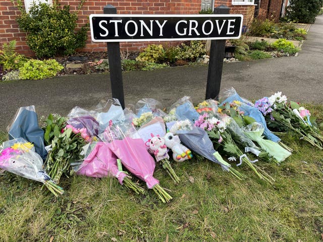 Floral tributes left near a house in Costessey near Norwich after four people were found dead inside the property. 